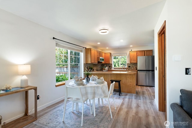 3828 Sutton Pl, Anacortes, WA 98221 - dining area featuring light wood finished floors, baseboards, and recessed lighting