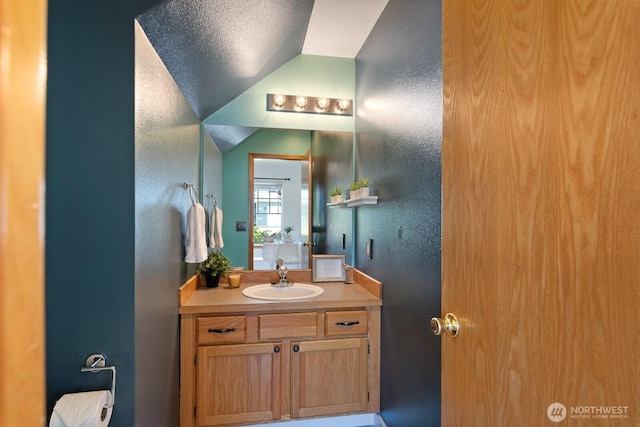 3828 Sutton Pl, Anacortes, WA 98221 - bathroom featuring a textured wall, vanity, lofted ceiling, and toilet