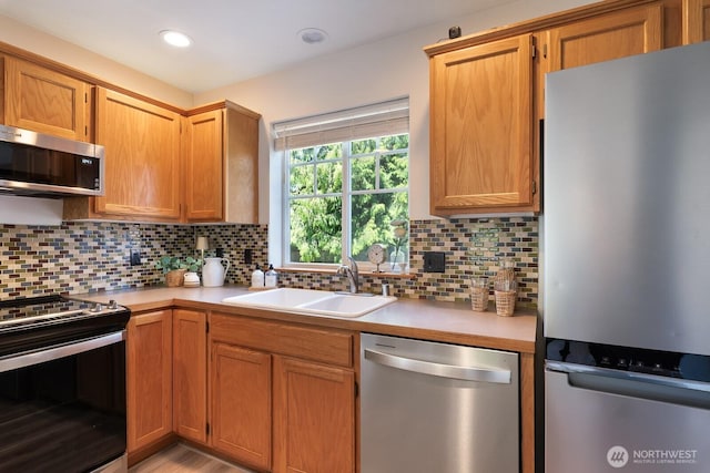 3828 Sutton Pl, Anacortes, WA 98221 - kitchen featuring stainless steel appliances, a sink, light countertops, and decorative backsplash