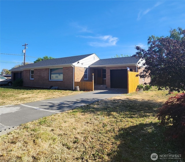 234 SW 15th Ave, Ephrata, WA 98823 - ranch-style house featuring concrete driveway, a garage, brick siding, and a front lawn