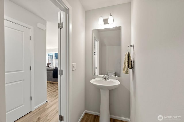 9206 Conine St SE, Yelm, WA 98597 - bathroom with wood finished floors, baseboards, and a sink