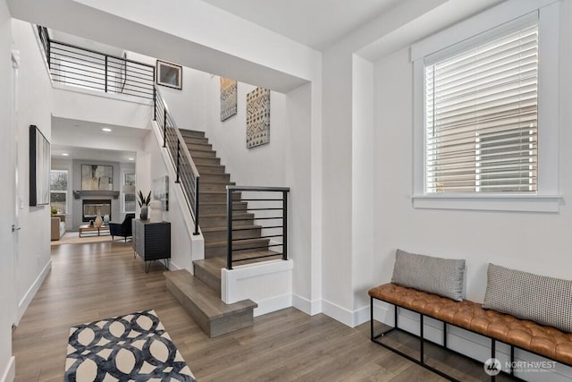 19507 81st Pl NE Unit 3, Kenmore, WA 98028 - foyer entrance featuring baseboards, stairway, wood finished floors, a fireplace, and healthy amount of natural light