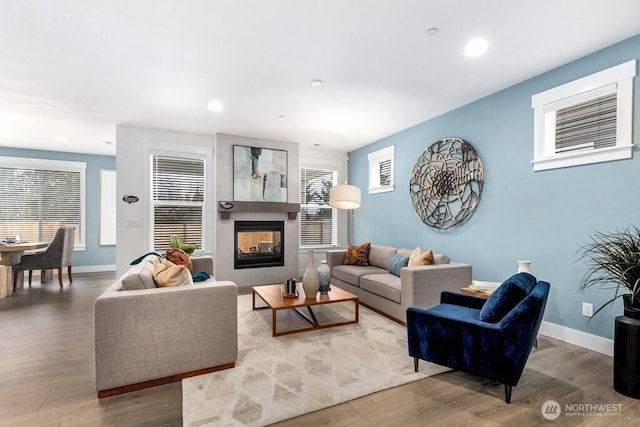 19507 81st Pl NE Unit 3, Kenmore, WA 98028 - living area featuring wood finished floors, baseboards, recessed lighting, a multi sided fireplace, and healthy amount of natural light