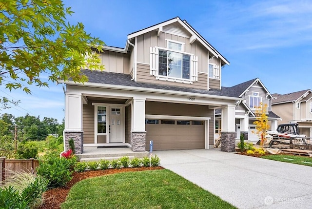 19507 81st Pl NE Unit 3, Kenmore, WA 98028 - craftsman house with board and batten siding, a garage, driveway, stone siding, and covered porch