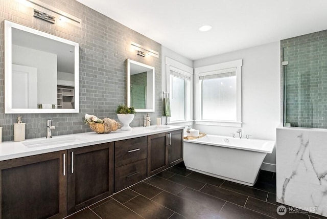 19507 81st Pl NE Unit 3, Kenmore, WA 98028 - bathroom with a soaking tub, double vanity, backsplash, recessed lighting, and tile patterned floors