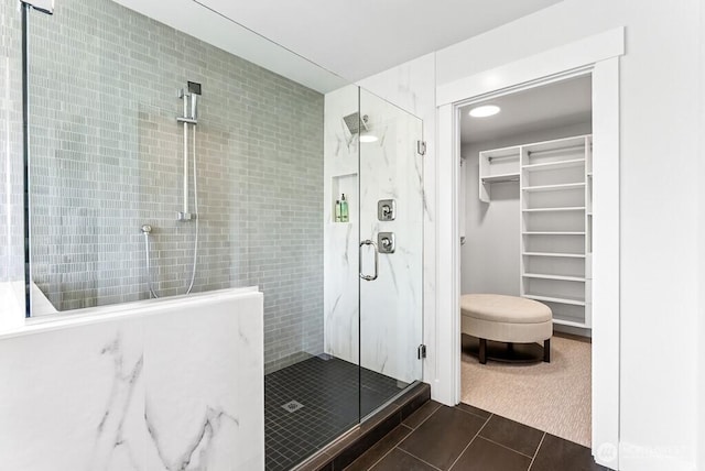 19507 81st Pl NE Unit 3, Kenmore, WA 98028 - bathroom featuring a stall shower, tile patterned floors, a walk in closet, and tile walls