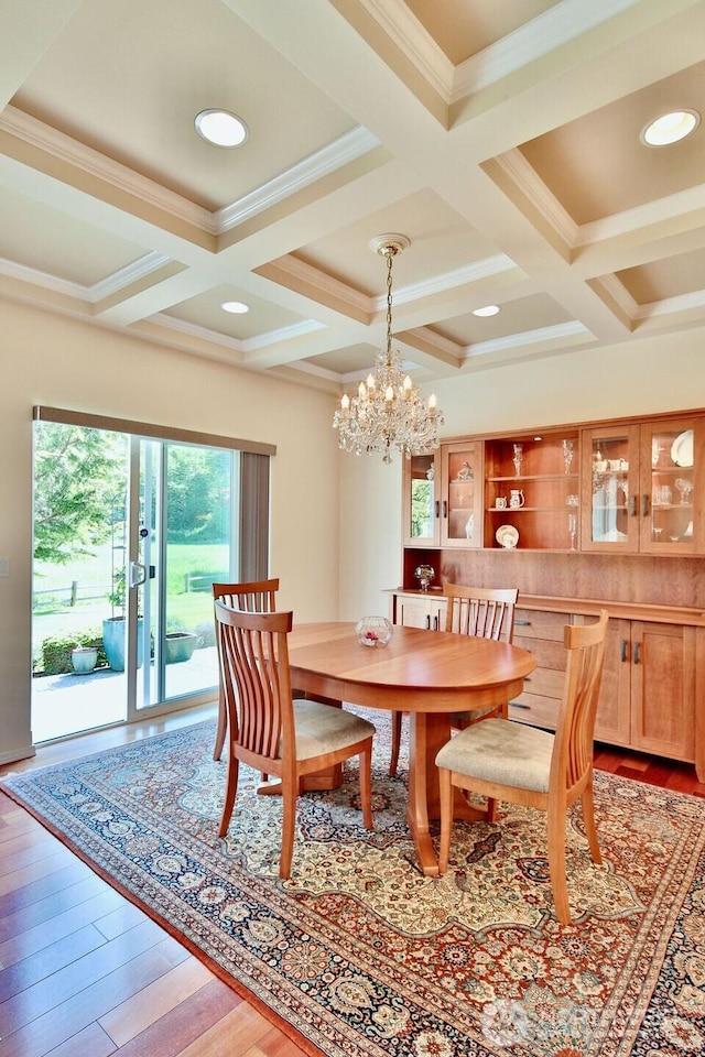 dining space with coffered ceiling, crown molding, and beam ceiling