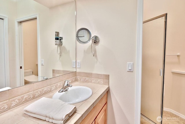 full bathroom with toilet, tile patterned flooring, and vanity