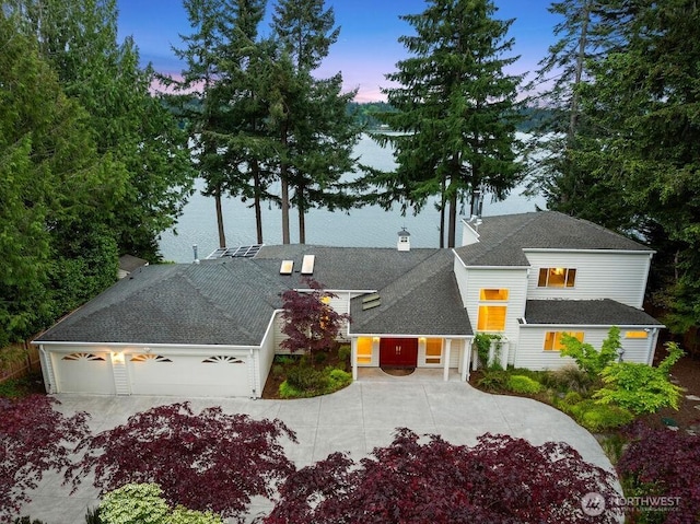 3236 Gravelly Beach Loop NW, Olympia, WA 98502 - view of front of home with driveway, a garage, and a chimney