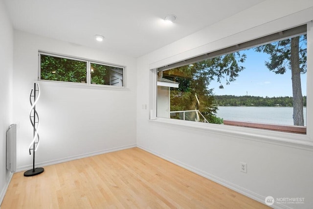 3236 Gravelly Beach Loop NW, Olympia, WA 98502 - empty room with baseboards, wood finished floors, a water view, and recessed lighting