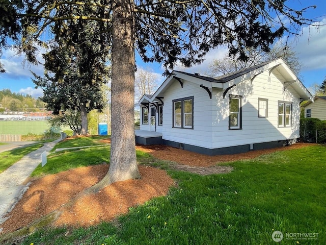 view of side of home featuring a yard