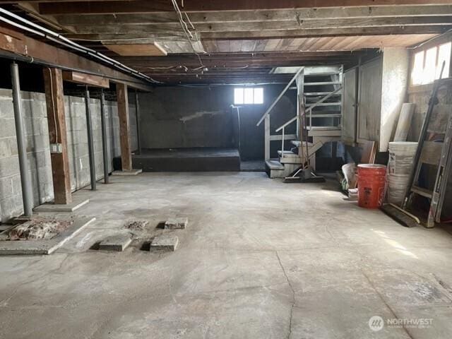 below grade area with plenty of natural light and stairs