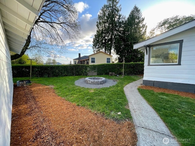view of yard with an outdoor fire pit