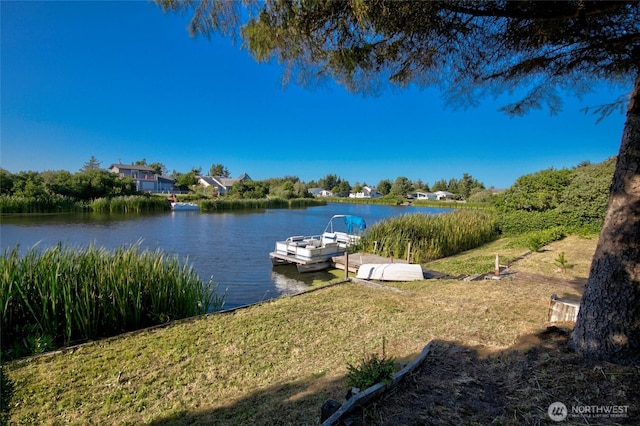 348 Cockle St SW, Ocean Shores, WA 98569 - dock area featuring a water view and a lawn