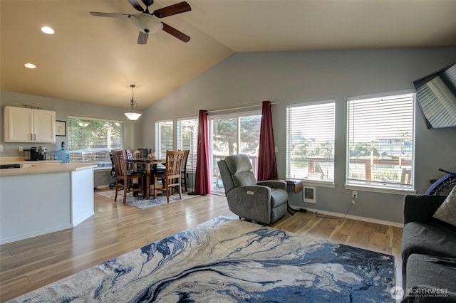 348 Cockle St SW, Ocean Shores, WA 98569 - living room featuring light wood finished floors, baseboards, ceiling fan, vaulted ceiling, and recessed lighting
