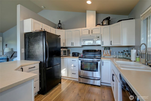 348 Cockle St SW, Ocean Shores, WA 98569 - kitchen featuring a sink, freestanding refrigerator, stainless steel range with electric cooktop, white microwave, and lofted ceiling