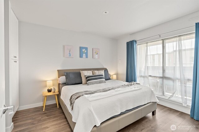 321 10th Ave S Unit 705, Seattle, WA 98104 - bedroom featuring wood finished floors and baseboards