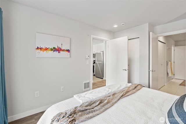 321 10th Ave S Unit 705, Seattle, WA 98104 - bedroom with freestanding refrigerator, baseboards, and recessed lighting