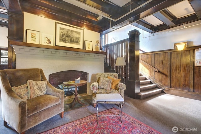 living area with carpet and stairway