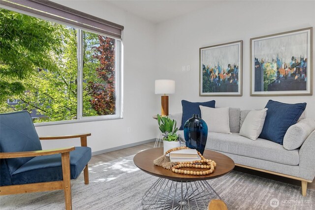 living area with wood finished floors and baseboards
