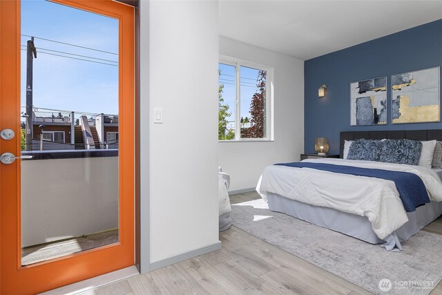 bedroom featuring wood finished floors and baseboards