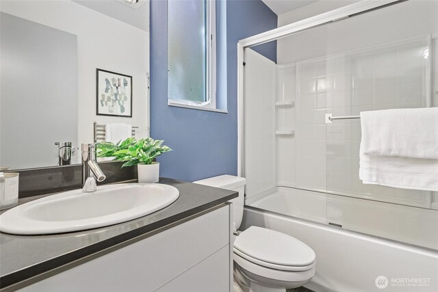 full bath with toilet, vanity, and washtub / shower combination
