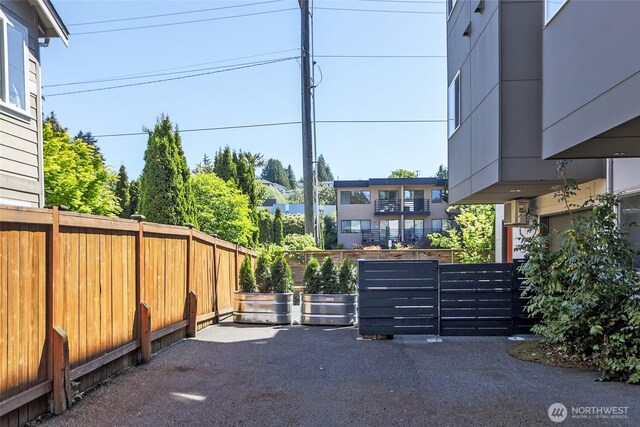 view of vehicle parking featuring fence
