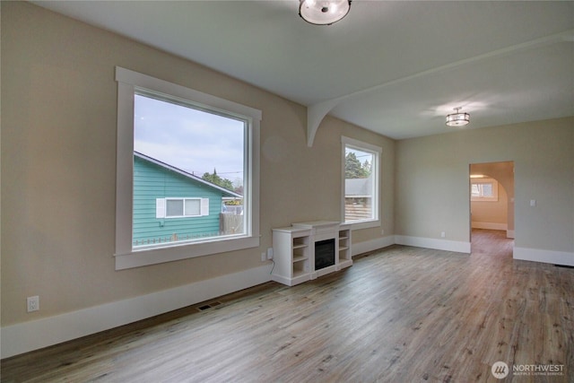 1813 10th St, Anacortes, WA 98221 - unfurnished living room featuring wood finished floors, baseboards, and a fireplace