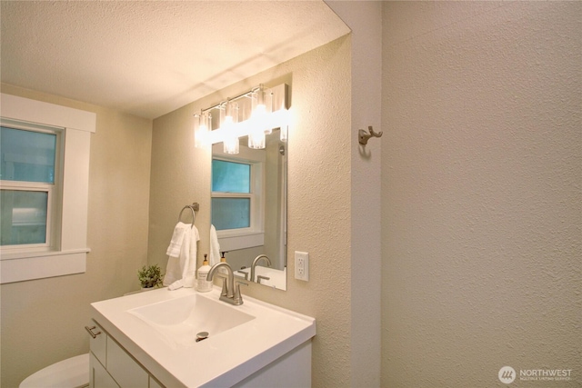 1813 10th St, Anacortes, WA 98221 - bathroom featuring vanity, toilet, a textured wall, and a textured ceiling