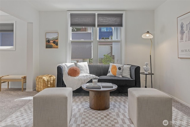 carpeted living room with baseboards