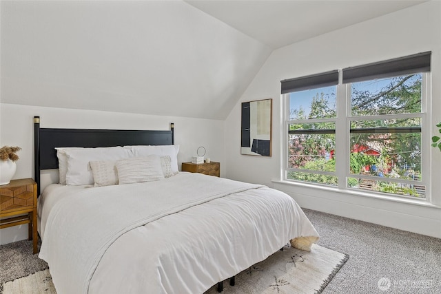 carpeted bedroom featuring vaulted ceiling