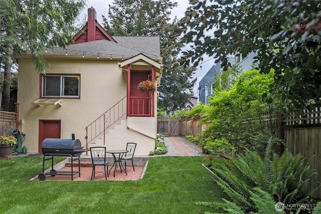 back of house featuring stucco siding, a patio, a shingled roof, and a chimney