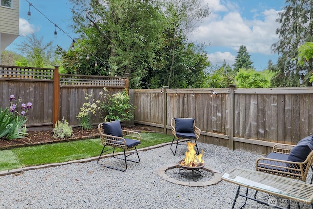 view of patio with a fire pit and a fenced backyard