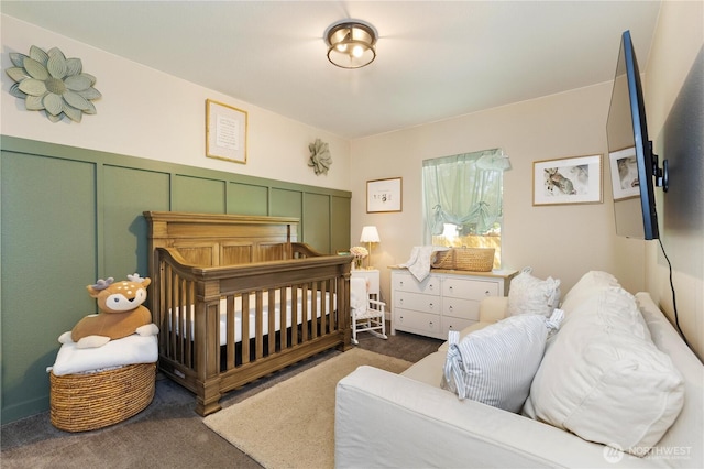 bedroom featuring carpet flooring and a crib