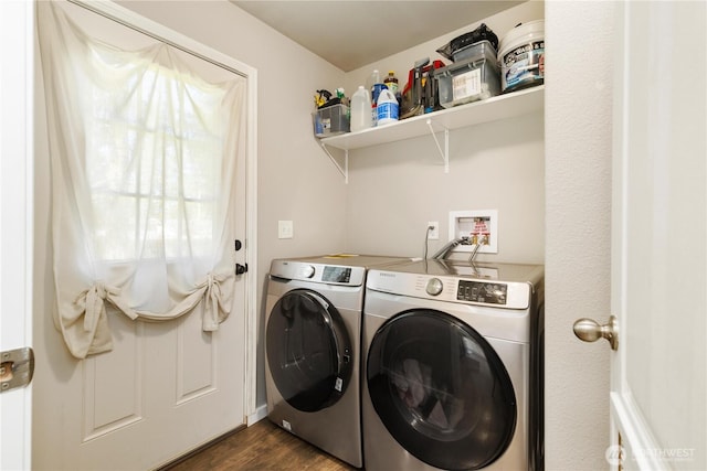 washroom featuring washing machine and clothes dryer and dark wood-type flooring