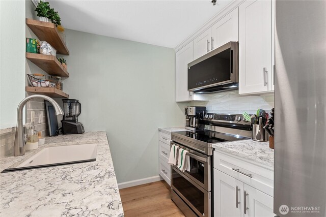 12515 109th Ct NE Unit B104, Kirkland, WA 98034 - kitchen featuring stainless steel appliances, open shelves, a sink, backsplash, and white cabinetry