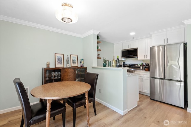 12515 109th Ct NE Unit B104, Kirkland, WA 98034 - kitchen with appliances with stainless steel finishes, white cabinetry, light wood-type flooring, crown molding, and backsplash