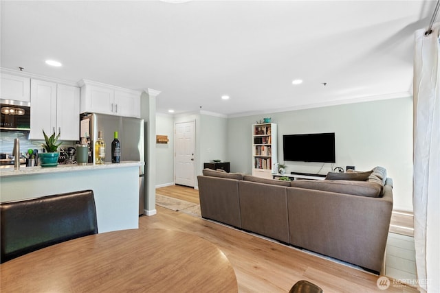 12515 109th Ct NE Unit B104, Kirkland, WA 98034 - living area featuring light wood-type flooring, recessed lighting, ornamental molding, and baseboards