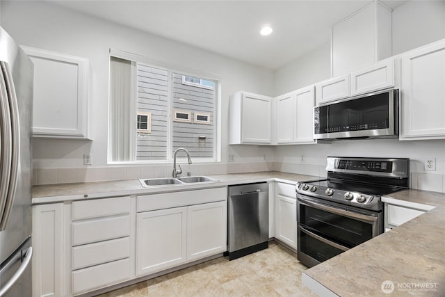 3516 Preston St NE, Lacey, WA 98516 - kitchen with stainless steel appliances, a sink, white cabinetry, light countertops, and recessed lighting
