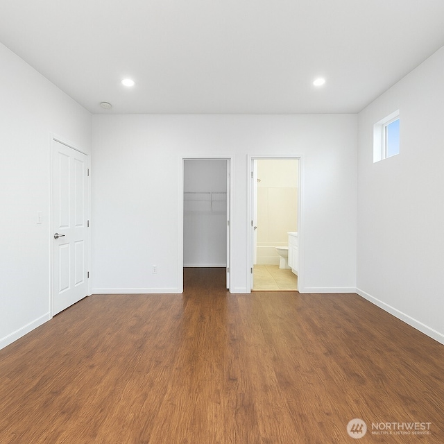 3516 Preston St NE, Lacey, WA 98516 - unfurnished bedroom with wood finished floors, a walk in closet, baseboards, and recessed lighting