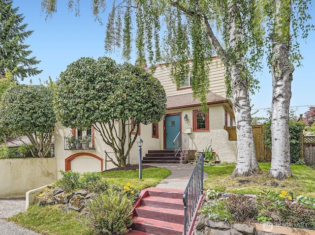 2523 Royal Ct E, Seattle, WA 98112 - view of front of house with stucco siding, fence, and entry steps