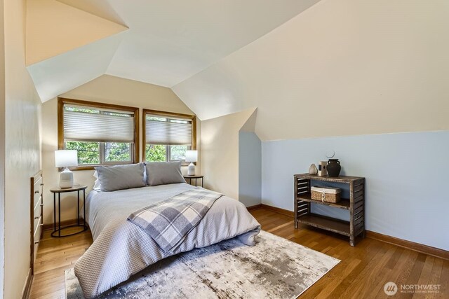 2523 Royal Ct E, Seattle, WA 98112 - bedroom featuring vaulted ceiling, wood finished floors, and baseboards