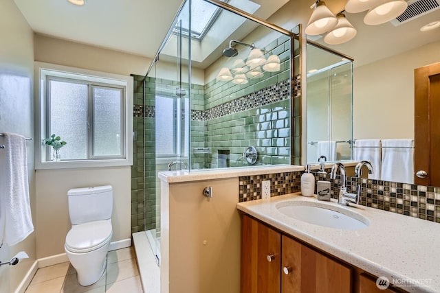 2523 Royal Ct E, Seattle, WA 98112 - bathroom with toilet, tile patterned floors, a stall shower, and decorative backsplash