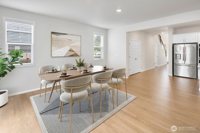 dining area featuring baseboards, light wood-style floors, and recessed lighting