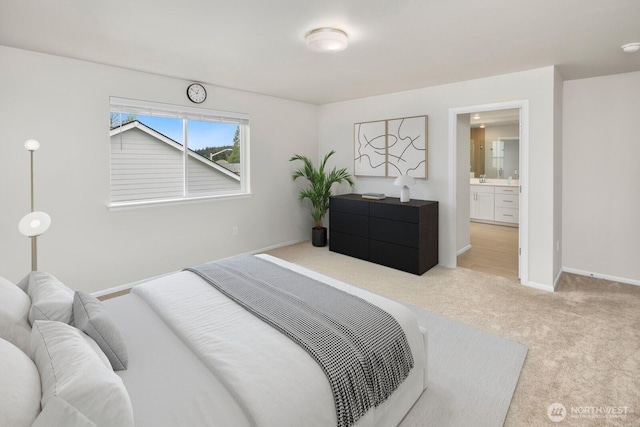 carpeted bedroom with baseboards and ensuite bathroom