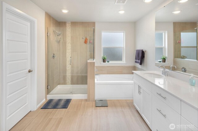 bathroom with vanity, visible vents, recessed lighting, a stall shower, and a garden tub