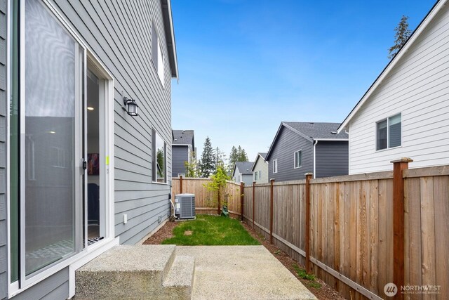 exterior space featuring a patio, a fenced backyard, and central AC