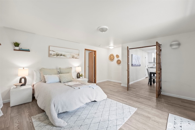 bedroom featuring baseboards and light wood-type flooring