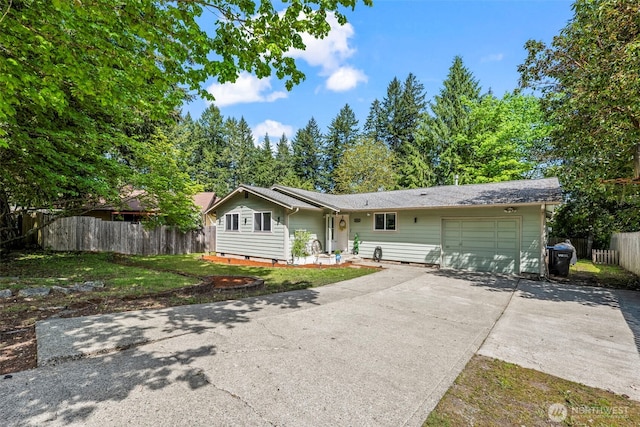 view of front of house featuring fence, a garage, and concrete driveway