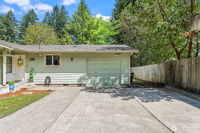 exterior space featuring driveway, a garage, fence, and crawl space
